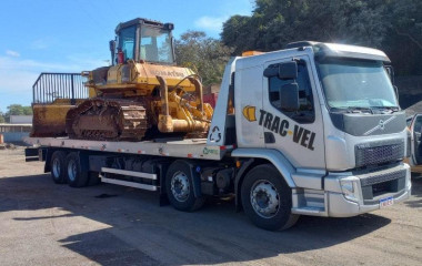 O caminhão de plataforma hidráulica é muito útil para transportar máquinas e equipamentos pesados. 